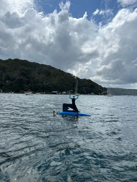 Sailor standing on top of Waszp in Pittwater at Royal Prince Alfred Yacht Club