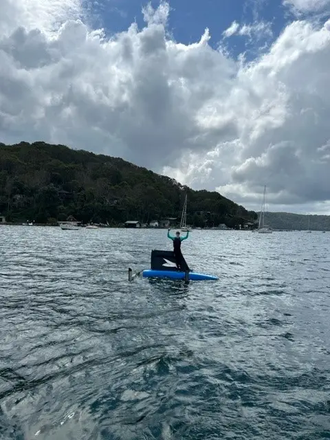 Sailor standing on top of Waszp in Pittwater at Royal Prince Alfred Yacht Club
